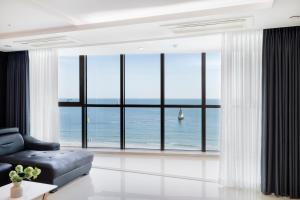 a living room with a view of the ocean at Pale De Cz Condo in Busan