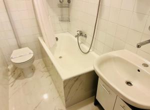 a white bathroom with a toilet and a sink at Apartment Niksa in Novigrad Dalmatia +39 photos