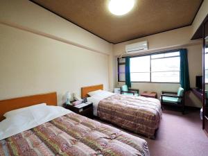 Postel nebo postele na pokoji v ubytování Sky Heart Hotel Shimonoseki