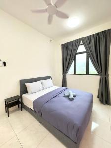a bedroom with a bed with a ceiling fan and a window at TheSun #BayanLepas#QueensbayMall#PISA#USM in Bayan Lepas