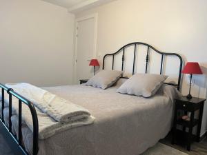 a bedroom with a bed with two pillows on it at Appartement Ciboure, 3 pièces, 4 personnes - FR-1-239-927 in Ciboure