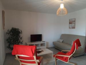 a living room with a couch and a tv at Appartement T2 Tout Confort Centre-Ville Vieux-Boucau avec Parking Privatif et Proche des Plages - FR-1-239-926 in Vieux-Boucau-les-Bains