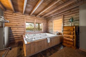 a large bath tub in a wooden room with a window at Ridgecrest in Gatlinburg +42 photos