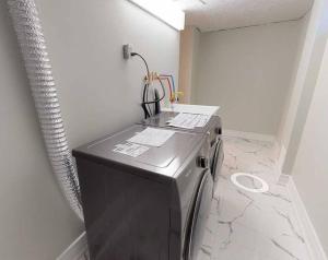 a washer and dryer sitting in a room at 3-Bedroom House in Little Italy Downtown-Free Parking in Toronto