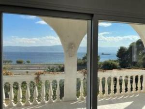 a view of the ocean from a window at Country house by the Sea 200m & Sea View with garden in Agioi Theodoroi