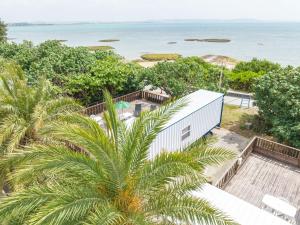 an aerial view of a house and the ocean at DUOマーメイドステイ in Nakagusuku
