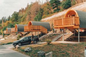 a car parked in front of a building with decks at Frankenwald Chalets - Chalets in Wilhelmsthal