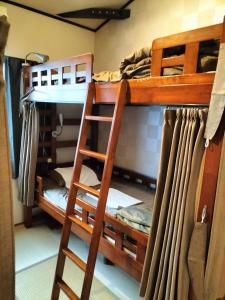 a bunk bed with a ladder in a room at Kyoto Guesthouse Roujiya in Kyoto