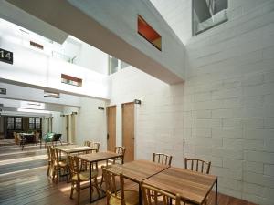 a dining room with wooden tables and chairs at Lantern Hotel in Kuala Lumpur +31 photos