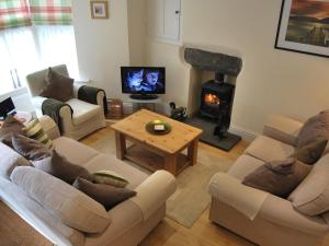 a living room with two couches and a fireplace at The Nook in Ambleside