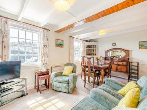 a living room with a couch and a table at Memory Cottage in Mevagissey