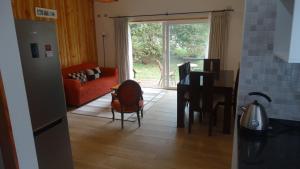 a living room with a red couch and a table at Parcela Parulus in Valdivia