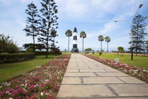 a walkway leading to a lighthouse in a park at MLA Apartments - Alcanfores in Lima