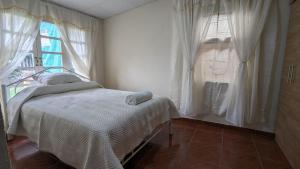 a bedroom with a bed and a window at La casita in Cochabamba