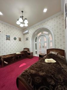 a bedroom with a large bed and a large window at Imran Guest House in Samarkand