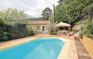 a swimming pool in the backyard of a house at Gorgeous Home In Les Salles Du Gardon With Kitchen in Les Salles-du-Gardon