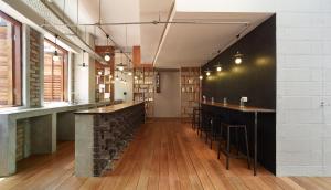 a bar with a row of bar stools at Lantern Hotel in Kuala Lumpur