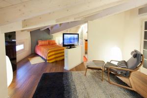 Schlafzimmer mit einem Kingsize-Bett und einem TV in der Unterkunft Villa Laila Bed & Breakfast in Lodi