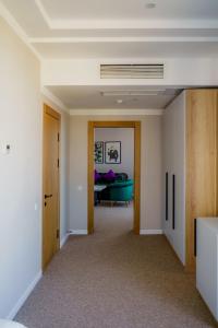 a hallway with a living room with a couch at Graf Hotel in Shymkent