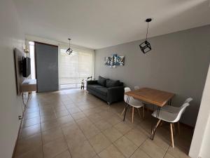 a living room with a table and a couch at Hermoso duplex con estacionamiento in Guaymallen