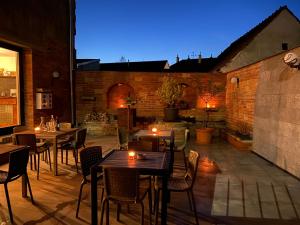 eine Terrasse mit Tischen und Stühlen mit Beleuchtung in der Unterkunft Penzion Za radnicí in Valtice