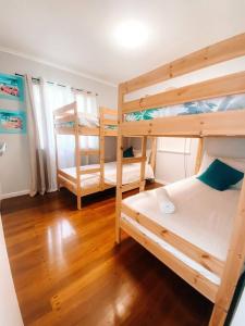 2 stapelbedden in een kamer met houten vloeren bij Beach Boutique With River View in Maroochydore