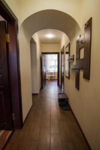 a hallway with a tile floor in a house at Pechersky Kvartal Apartments in Kyiv
