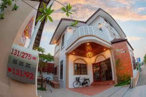 a building with a sign in front of it at Baan Hall Hostel in Khon Kaen