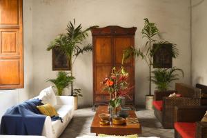 a living room with a couch and a table with plants at Casa Gaitana - Alma Hotels in Santa Marta