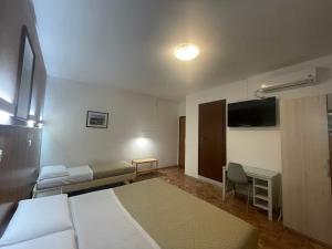 a hotel room with a bed and a flat screen tv at 216 Venice in Mestre