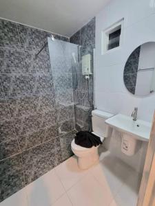 a bathroom with a shower and a toilet and a sink at โรงแรมเกียรตินคร (Kiatnakhon Hotel) in Nakhon Si Thammarat