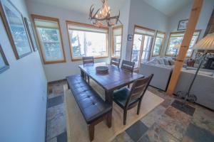 a dining room with a table and chairs and a couch at Quicksilver 1626 in Keystone