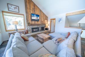 a living room with a couch and a fireplace at Quicksilver 1626 in Keystone