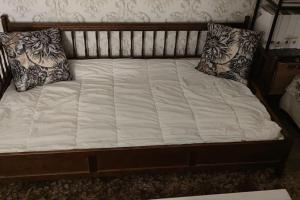 a bed with two pillows on top of it at Kaunis omakotitalo Sahalahdessa 