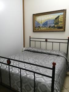 a bedroom with a bed and a picture on the wall at B&B da Maria & Renato il Lago Trattoria in Mirabella Eclano