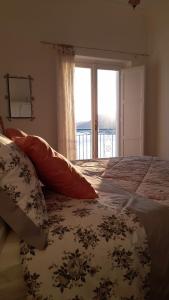 a bedroom with a bed with a large window at Panoramic Sea View Balcony Apartment in the Heart of Praiano, Casa Mimì Junior in Praiano +17 photos