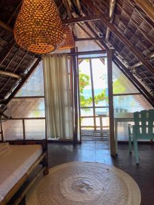 a room with a table and a chandelier at Kasa Raya By The Sea in Tibiao