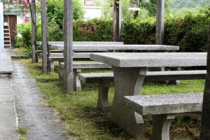 a row of stone benches in a park at OSTERIA RUBINO DA PAOLO in Acquarossa