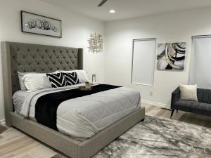 a bedroom with a large bed and a chair at Atlanta Elegance in Atlanta