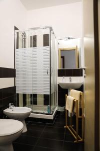 a bathroom with a shower and a sink and a toilet at Aura Home rent of rooms with shared kitchen in Bari