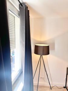 a lamp in a room next to a window at City Loft in Toplage Mainz-Kastel in Wiesbaden