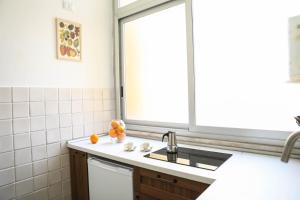 a kitchen with a sink and a window at Aura Home rent of rooms with shared kitchen in Bari
