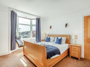 a bedroom with a bed and a large window at Number 10 in Dartmouth