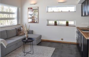 a living room with a couch and a table at Lovely Home In Geilo With Kitchen in Dagali