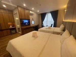 Postel nebo postele na pokoji v ubytování HO TRAM GOLDEN HOTEL