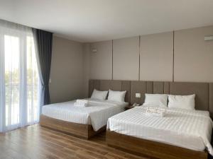 Postel nebo postele na pokoji v ubytování HO TRAM GOLDEN HOTEL