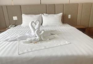 Postel nebo postele na pokoji v ubytování HO TRAM GOLDEN HOTEL