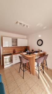 a kitchen with a table and chairs in a room at Apartmani Palma in Novalja