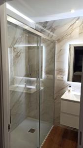 a bathroom with a shower and a sink at Agradable adosado en soto de llanera in Llanera