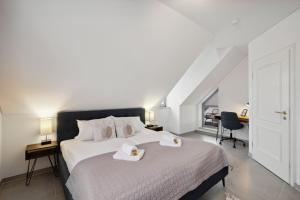 a bedroom with a bed with two towels on it at smooth living Apartments Augsburg Lechhausen - Free parking in Augsburg